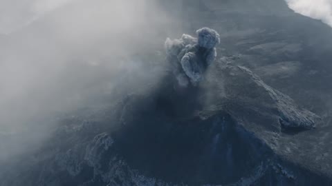 The drone contains incredible footage of a man rushing towards the opening of the volcano