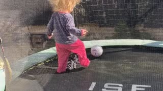 Little Girl with Wild Hair Plays on Trampoline