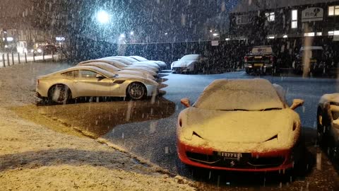 farrari sports car parking while snowing