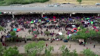 Drone video shows migrants under Texas bridge