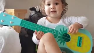 Adorable Baby Girl Hilariously Plays The Guitar