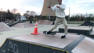 Skateboard guy jumps over traffic cone lands on ankle