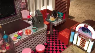 Adorable hamster enjoys spaghetti dinner in a toy diner