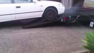 Man Has Trouble Getting Car onto Trailer