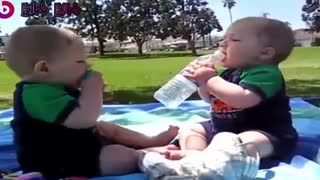 Twin Babies Fighting over a bottle of water