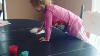 Sweet little girl loves helping mom clean the house