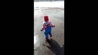 A child runs through puddles.