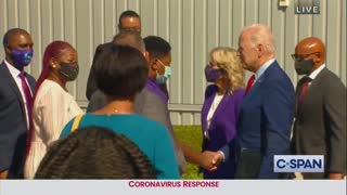 Biden, wearing no mask, approaches child at school