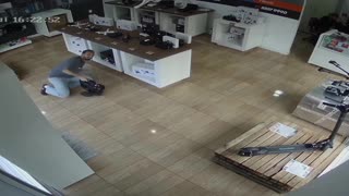 Man Falls Down While Riding Electric Unicycle Inside Shop