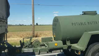 Military Vehicle Leaking Liquid Down the Highway