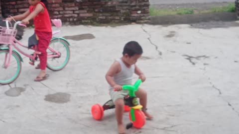 little boy playing bike