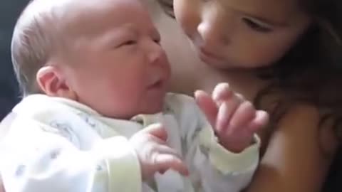 Big Sister Preciously Holds Newborn Baby Brother