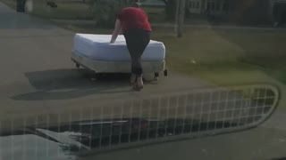 Girl Pushes Newly Bought Bed Down the Road