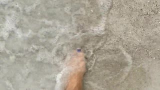 Bare feet at beach walking