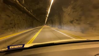 Driving into Very long tunnel under the mountains of Colorado