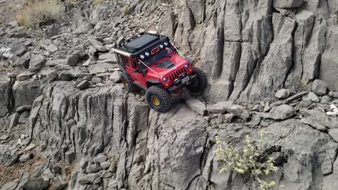 Red Jeep Traverses Across Sketchy Trail