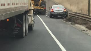 Truck Pushes Car Onto Freeway Shoulder