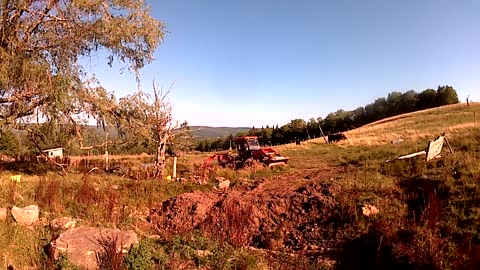 Time-lapse of pond building, but the back-hoe tips over into the pond. (Video 1)