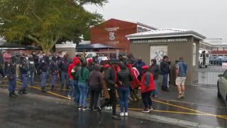 A small group of EFF supporters protest outside Brackenfell High School