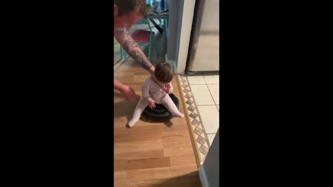 Baby Rides A Roomba