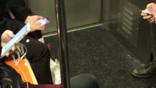 Person playing mobile phone game bejeweled subway