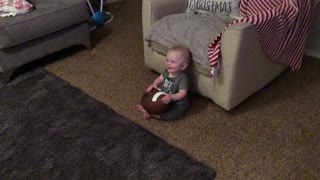Giggling baby finds daddy's football noises hilarious
