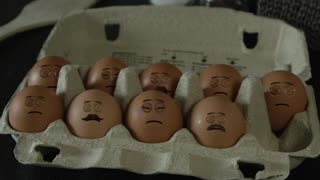 Man making eggs with faces on them