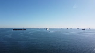 Drone video of long beach filled with ships