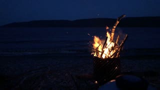 Outdoor fire cracking relaxing sound with ocean wave