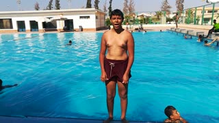 Funny Boy Performs Solid Strait Jumps At Swimming Pool
