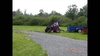 Kid learns to reverse and drive a tractor & trailer