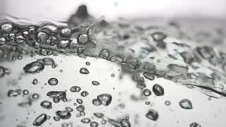 Amazing Bubbling water in slow motion Bubbling water with small bubbles and big bubbles. In grey