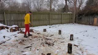 Having some fun while splitting firewood in the snowy mess.