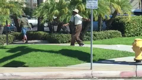 Older Gentleman Dancing his way across crosswalk in broad daylight