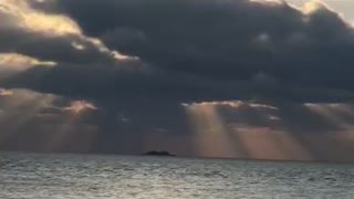 the sun hidden by clouds on the horizon