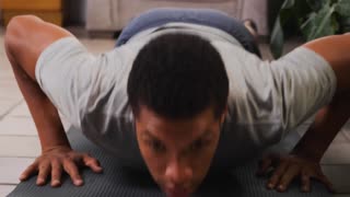 Young man doing push-ups on the floor