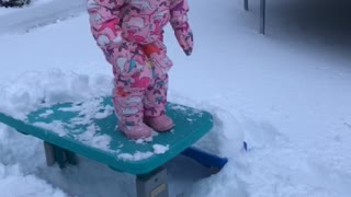 Toddler Face Plants into Snow off Picnic Table