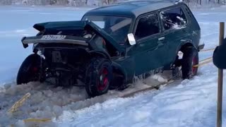 Car Collapses During Frozen Lake Recovery