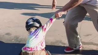 Young Girl Learning To Skateboard With Coach