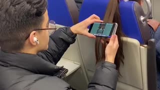 Passenger Hangs Phone From Hair