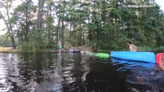 Guy runs across colorful upside down canoes fail falls into lake