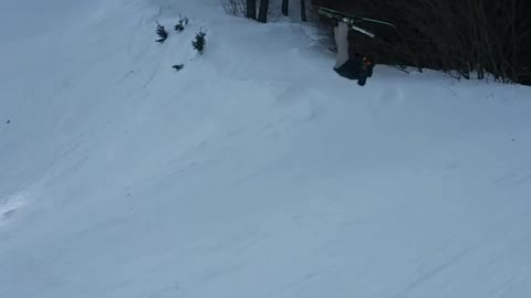 Guy skis off ramp and lands on his back